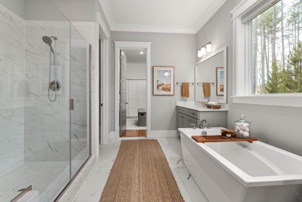 Luxury bathroom renovation with freestanding tub and marble tile by GC Renovations Inc